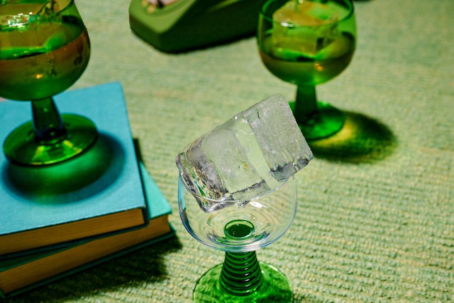 A large ice cube in a wine glass
