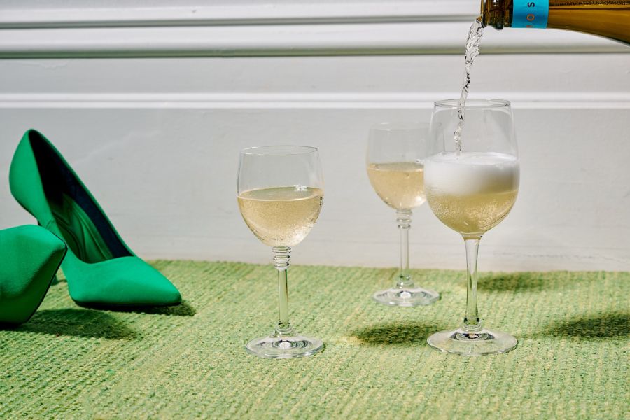 Sparkling wine poured into wine glasses 