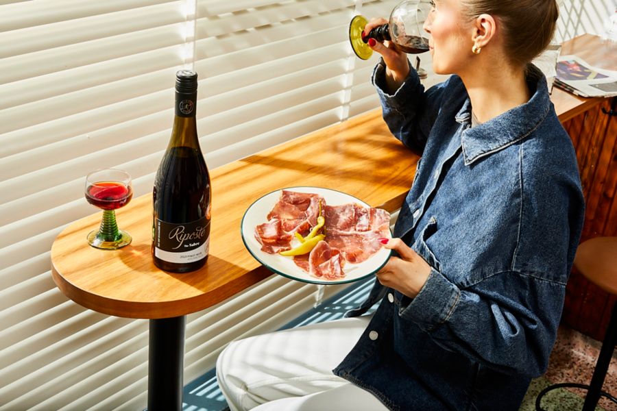 Enjoying a plate of bresaola with pinot noir