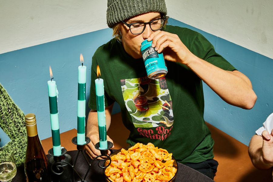 Man drinking Pirate Life South Coast Pale Ale with snacks