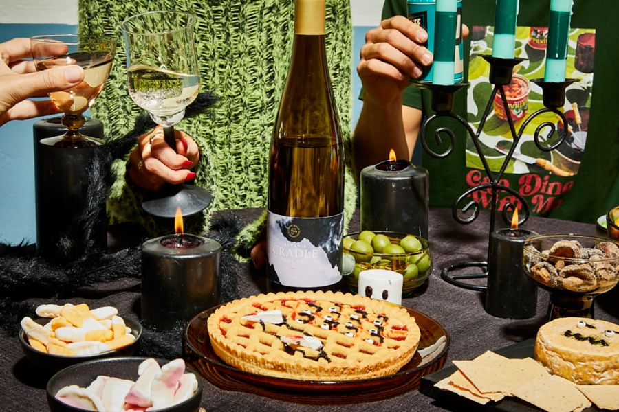 Bottle of Ghost Rock Cradle Pinot Gris on table surrounded by Halloween-themed pie and snacks