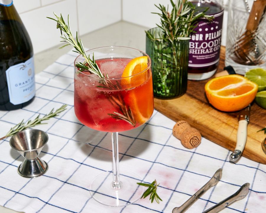 A Bloody Shiraz Gin Spritz, garnished with rosemary