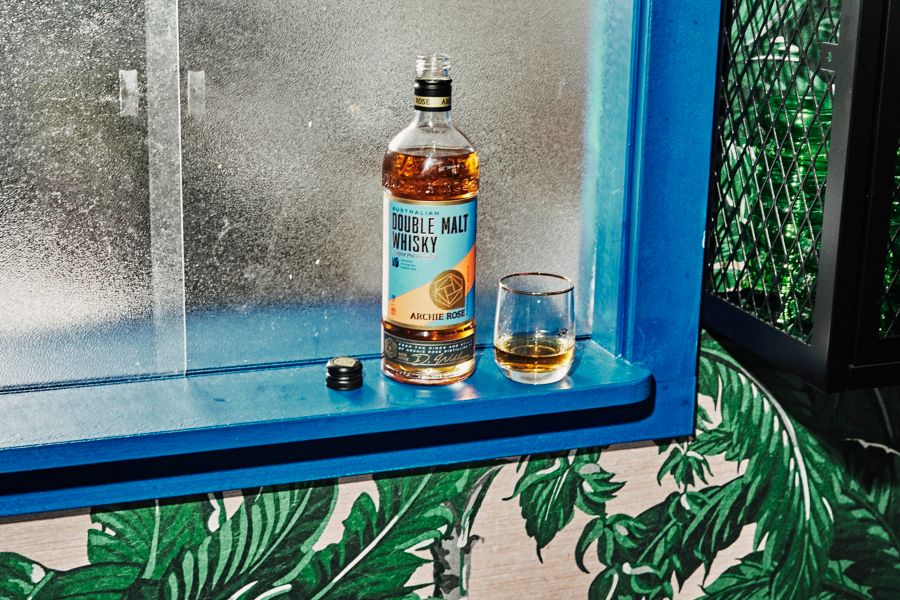 Double Malt Whisky and a glass on a ledge 