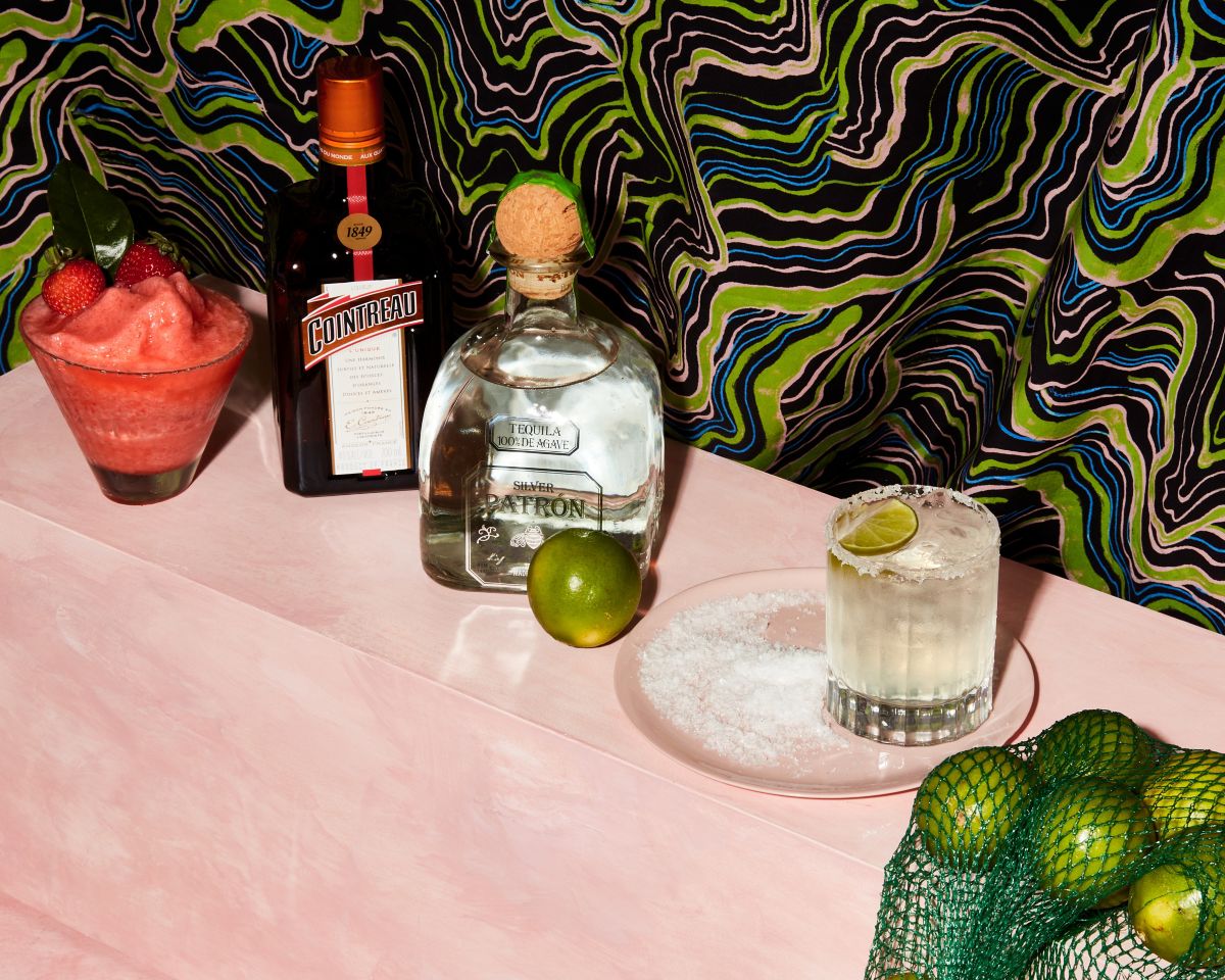 A Margarita next to a bag of limes 