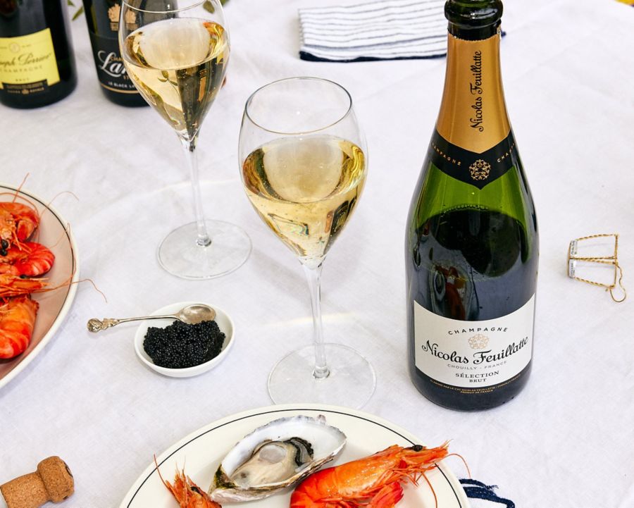 A glass of the Nicholas Feuillatte Selection Brut NV Champagne with seafood