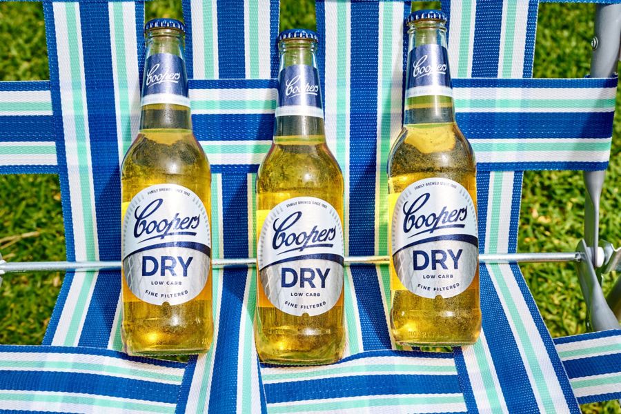 Three bottles of Coopers Dry on an outdoor chair