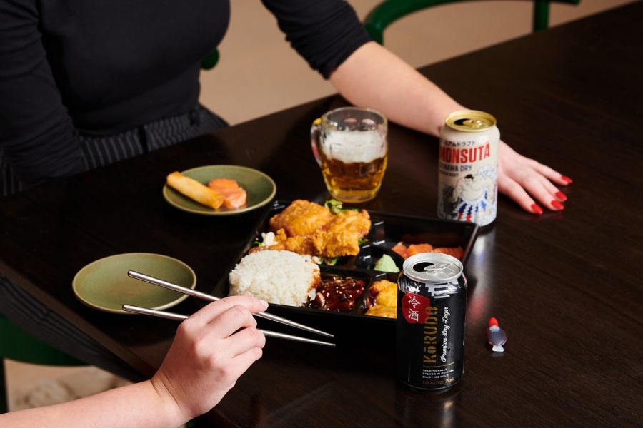 Picnic setting with a glass of chardonnay next to a bottle of McGuigan Zero Chardonnay