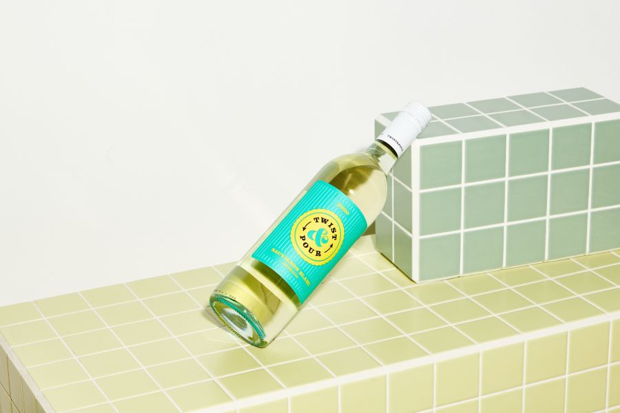 Picnic setting with a glass of chardonnay next to a bottle of McGuigan Zero Chardonnay