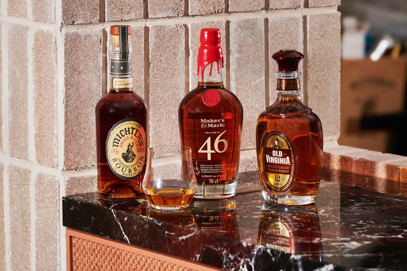 Three bottles of bourbon on a countertop