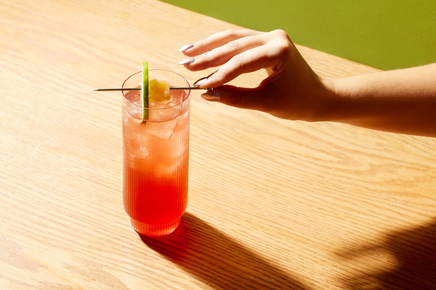 The El Diablo cocktail is garnished with skewered candied ginger and lime 