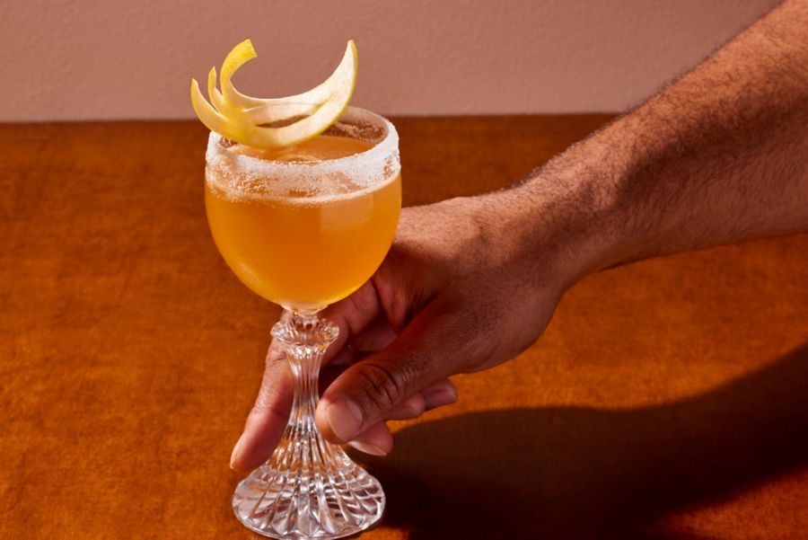 Holding a glass of the Brandy Crusta 