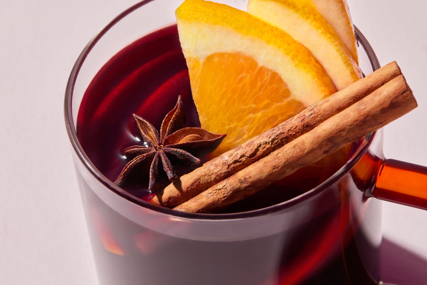 Mulled wine with a cinnamon quill, orange slices and star anise as garnish