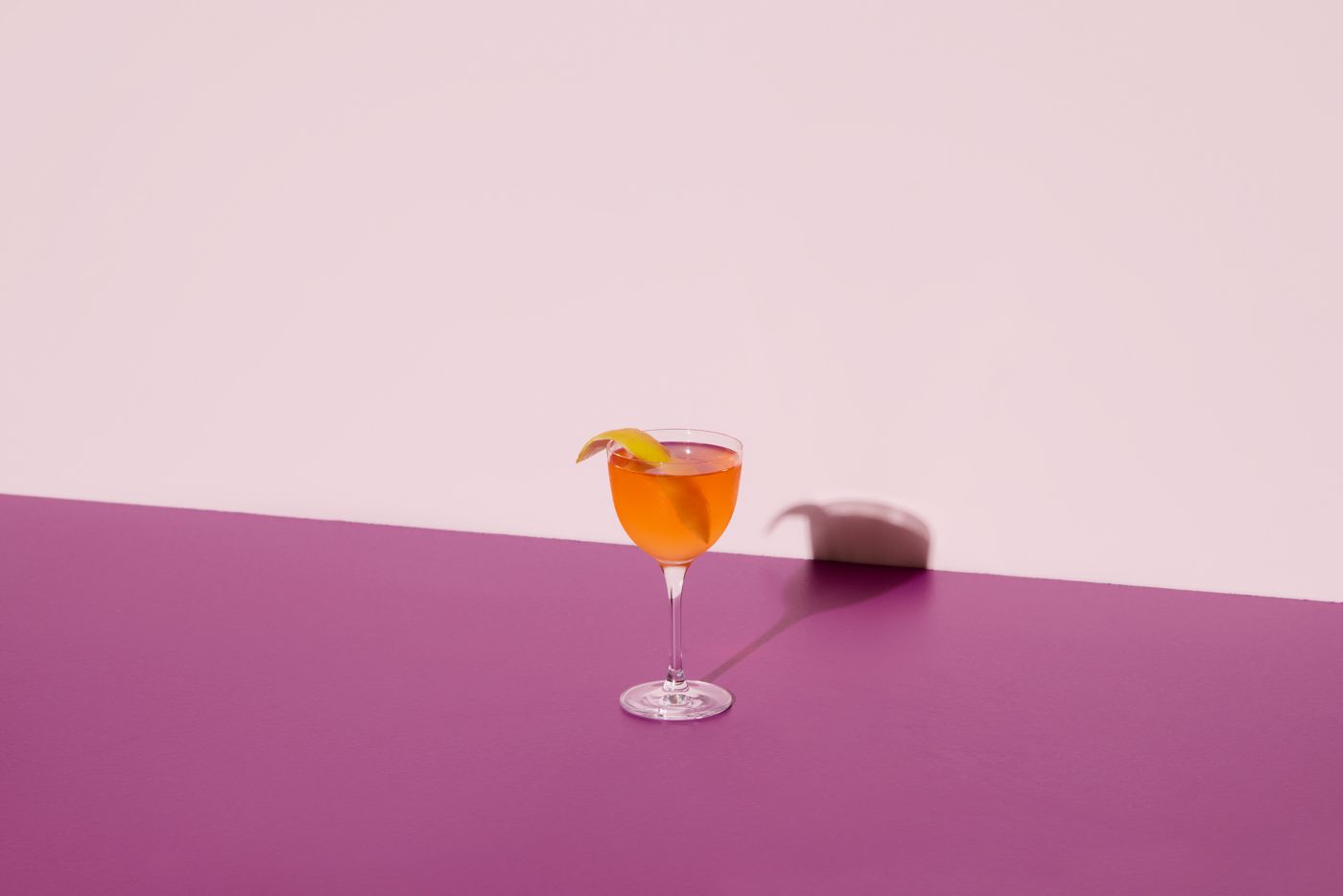 The Jasmine cocktail in a coupe glass with a lemon twist