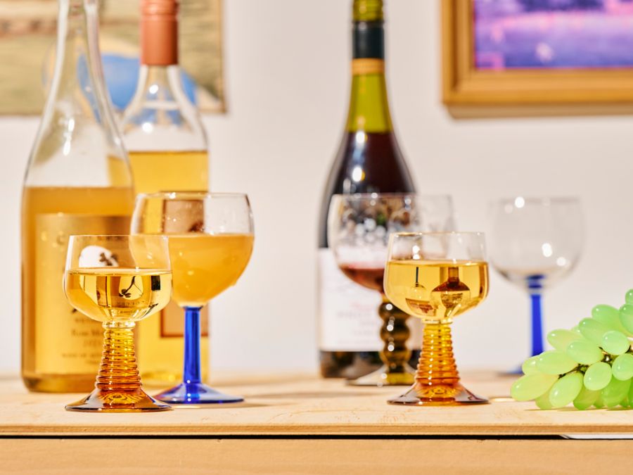 Glasses of white and orange wine on a table