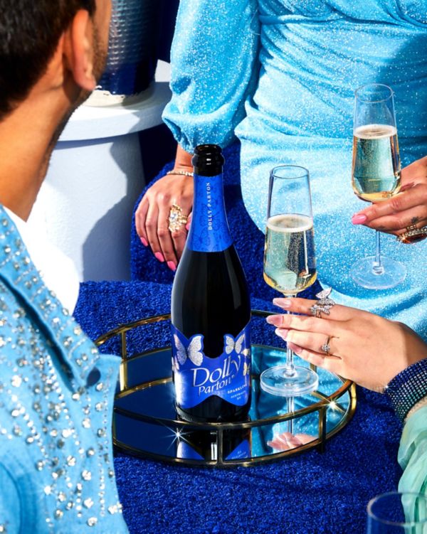 Bottle of Dolly Parton Wines Sparkling NV and Champagne flute
