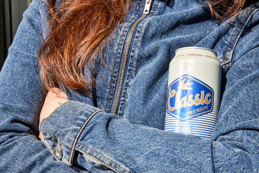 Holding a can of Young Henrys Classic Premium Lager