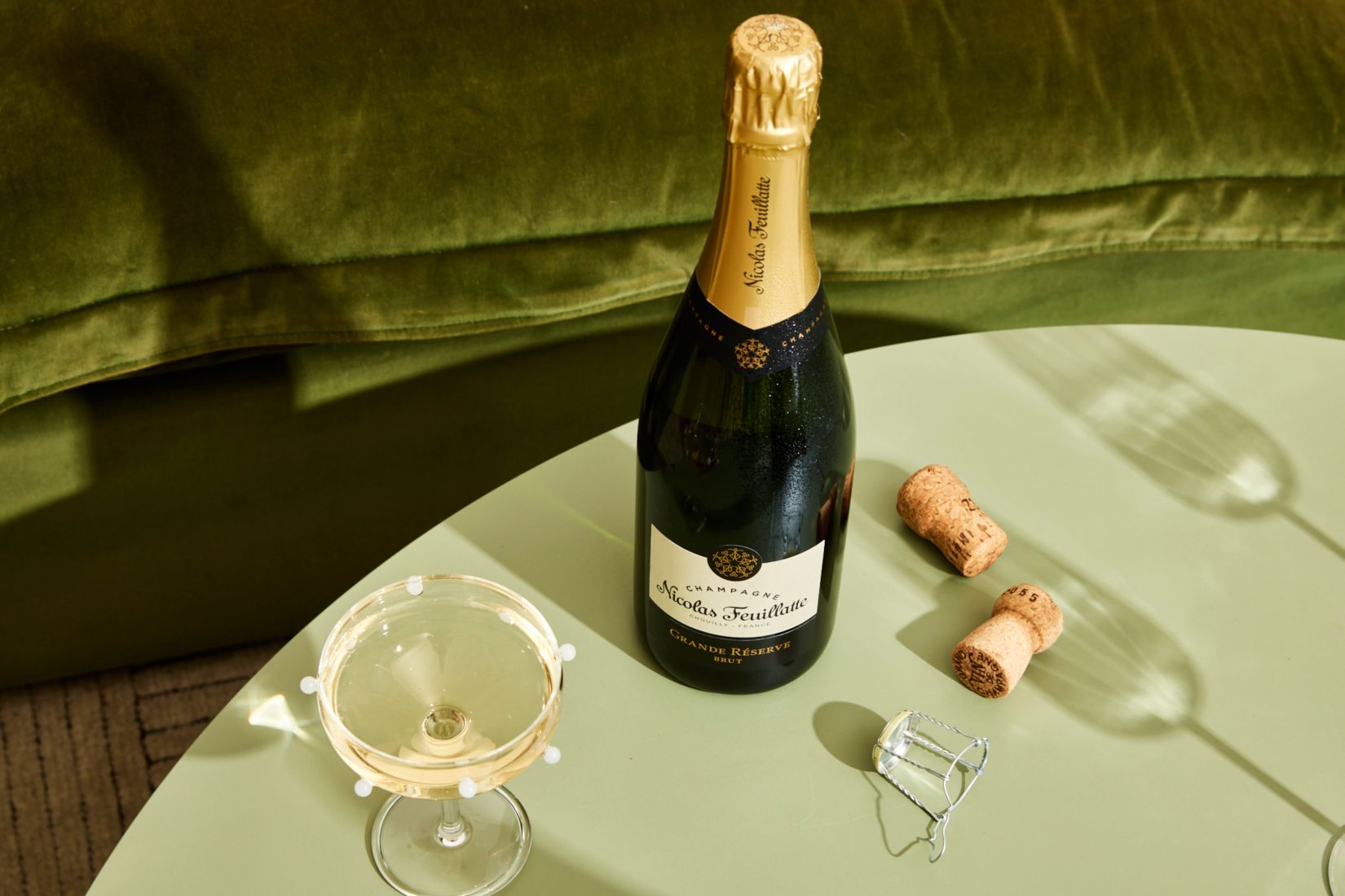 A bottle of Nicolas Feuillatte Champagne on a table 