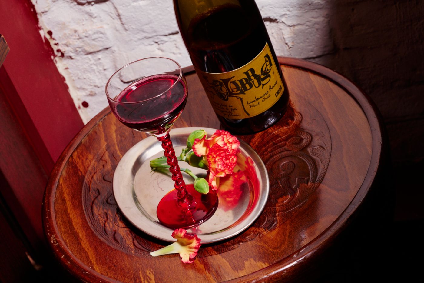 A bottle and a glass of Lambrusco sparkling red wine 