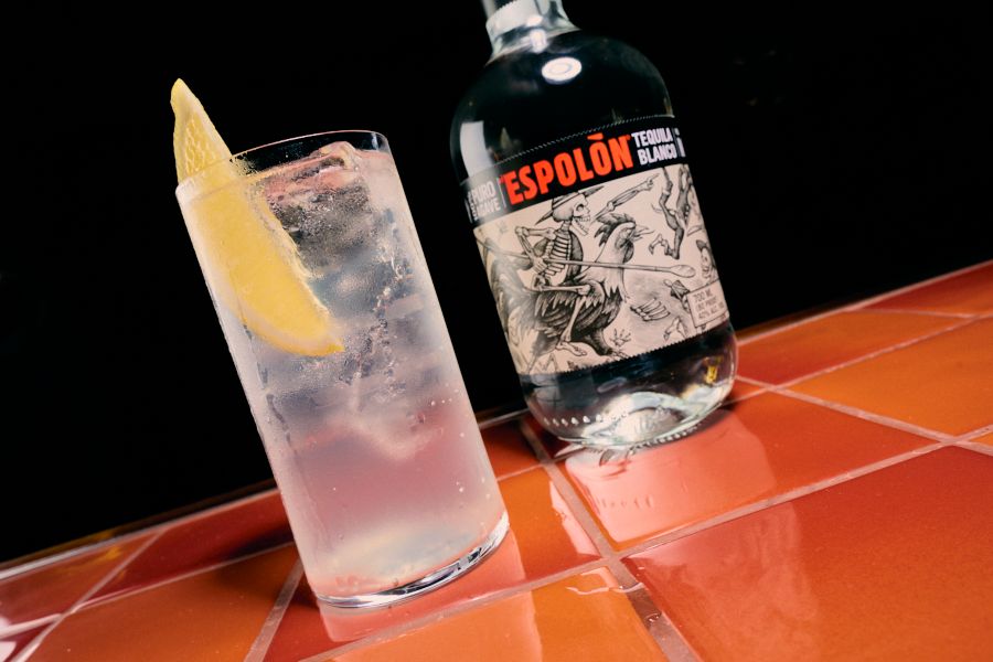 A Tequila & Tonic next to a bottle of Esplon Tequila 