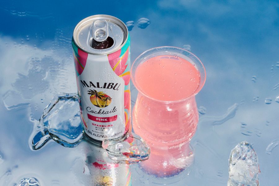 A glass and a can of the Malibu Pink with ice 