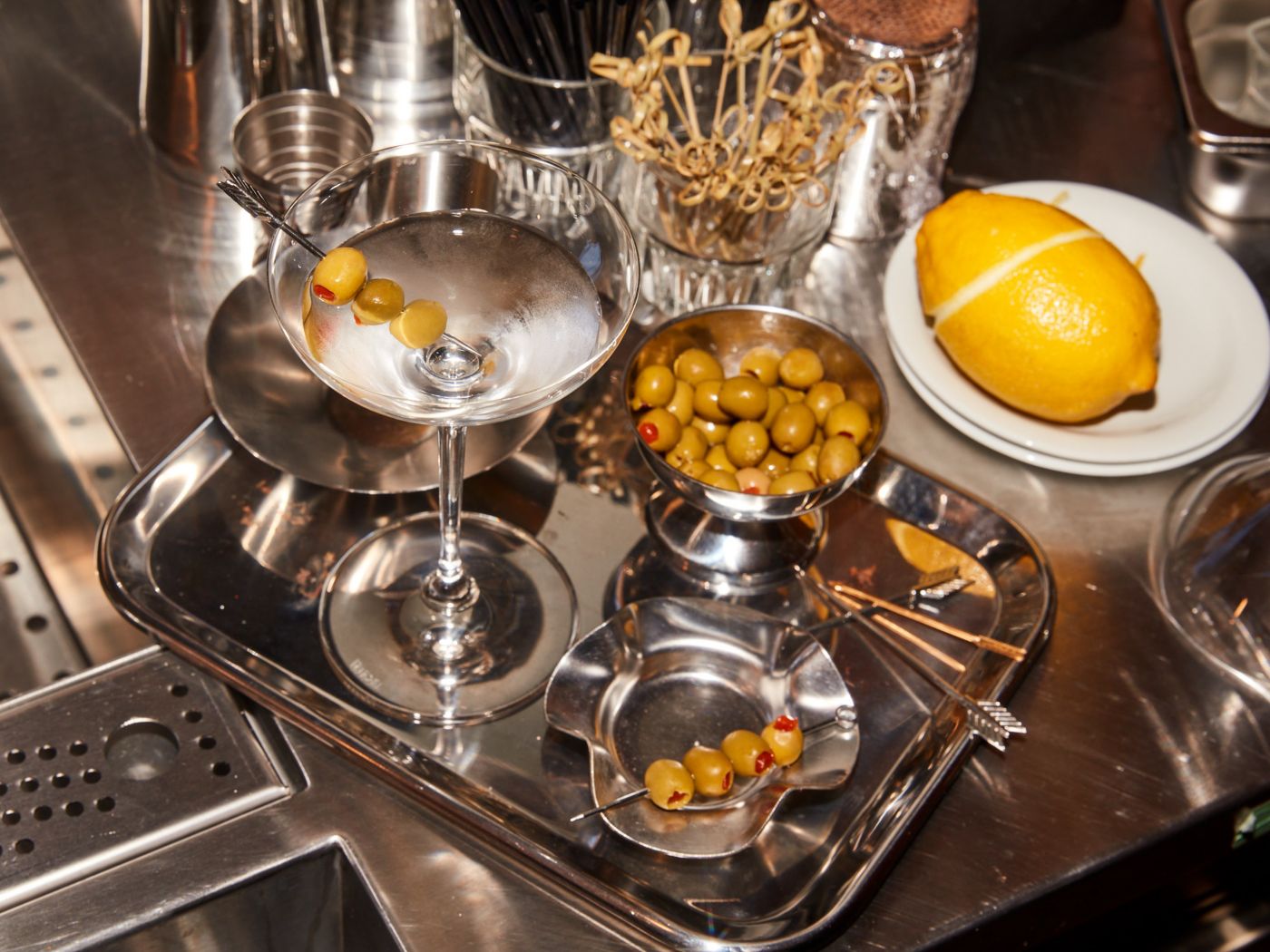 A cold Martini with olives on a table