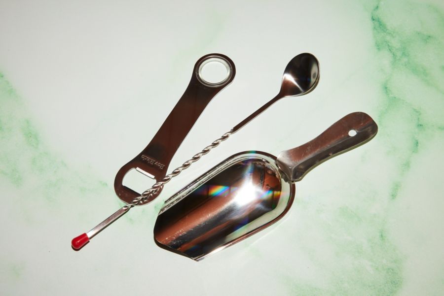 A cocktail stirrer, ice scoop and bottle opener