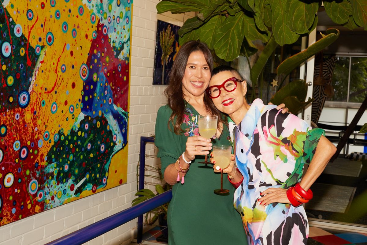 Jenny Kee and Grace Heifetz hugging and drinking a yuzu spritz cocktail