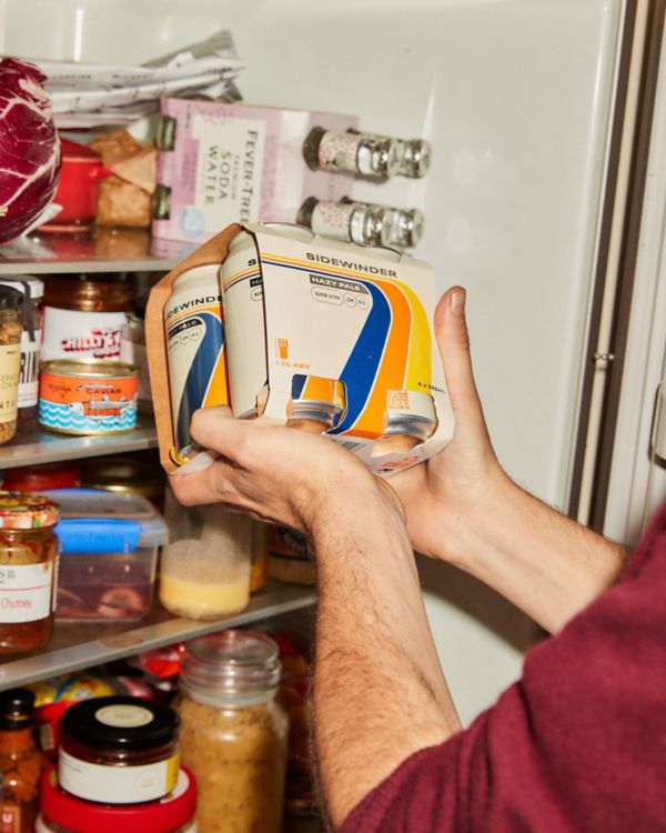 Pat grabbing Sidewinder Hazy Pale Ale beers from fridge