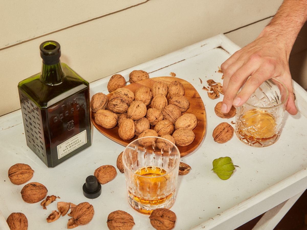 The Gospel Straight Australian Rye Whisky on table with bowl of walnuts 