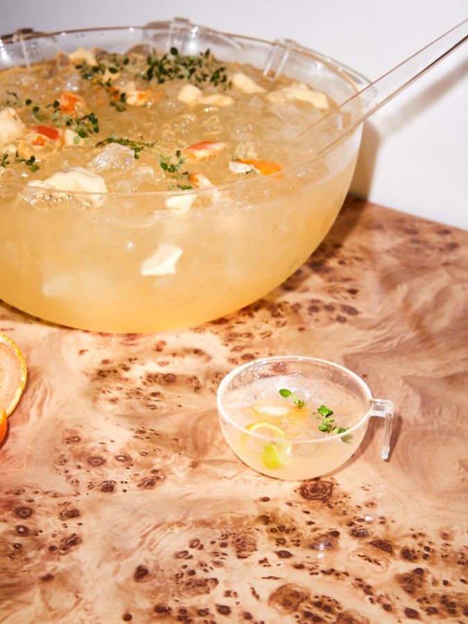 A punch bowl and cup of Mandarin White Sangria 