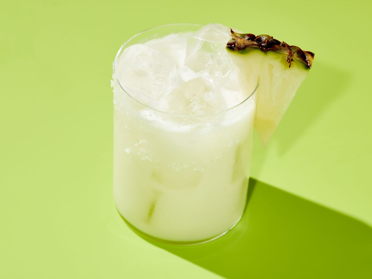 Garnish the Pineapple and Coconut Margarita with a pineapple wedge