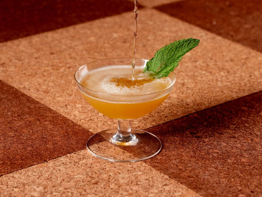 The Air Mail in a coupe with a mint leaf as garnish