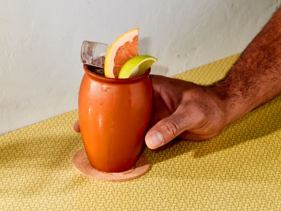 The Cantarito cocktail in a traditional Mexican clay cup 