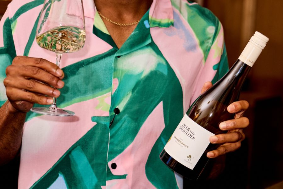 Holding a bottle of Oakridge Over The Shoulder Chardonnay
