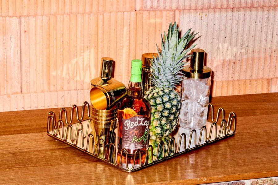 The Red Leg Pineapple Spiced Spirit with a pineapple and cocktail ingredients