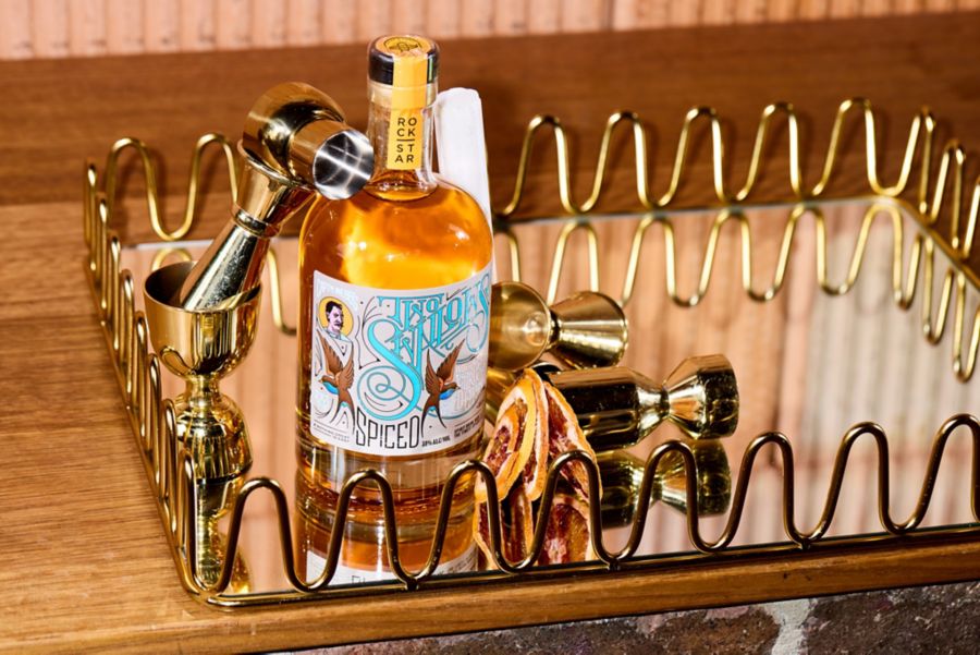 The Captain Webbs Two Swallows Citrus & Salted Caramel Spiced Rum with cocktail tools