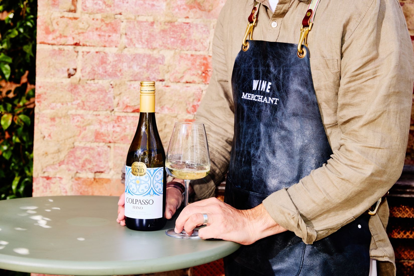 Bottle of the Colpasso Fiano wine along with some wine poured in glass