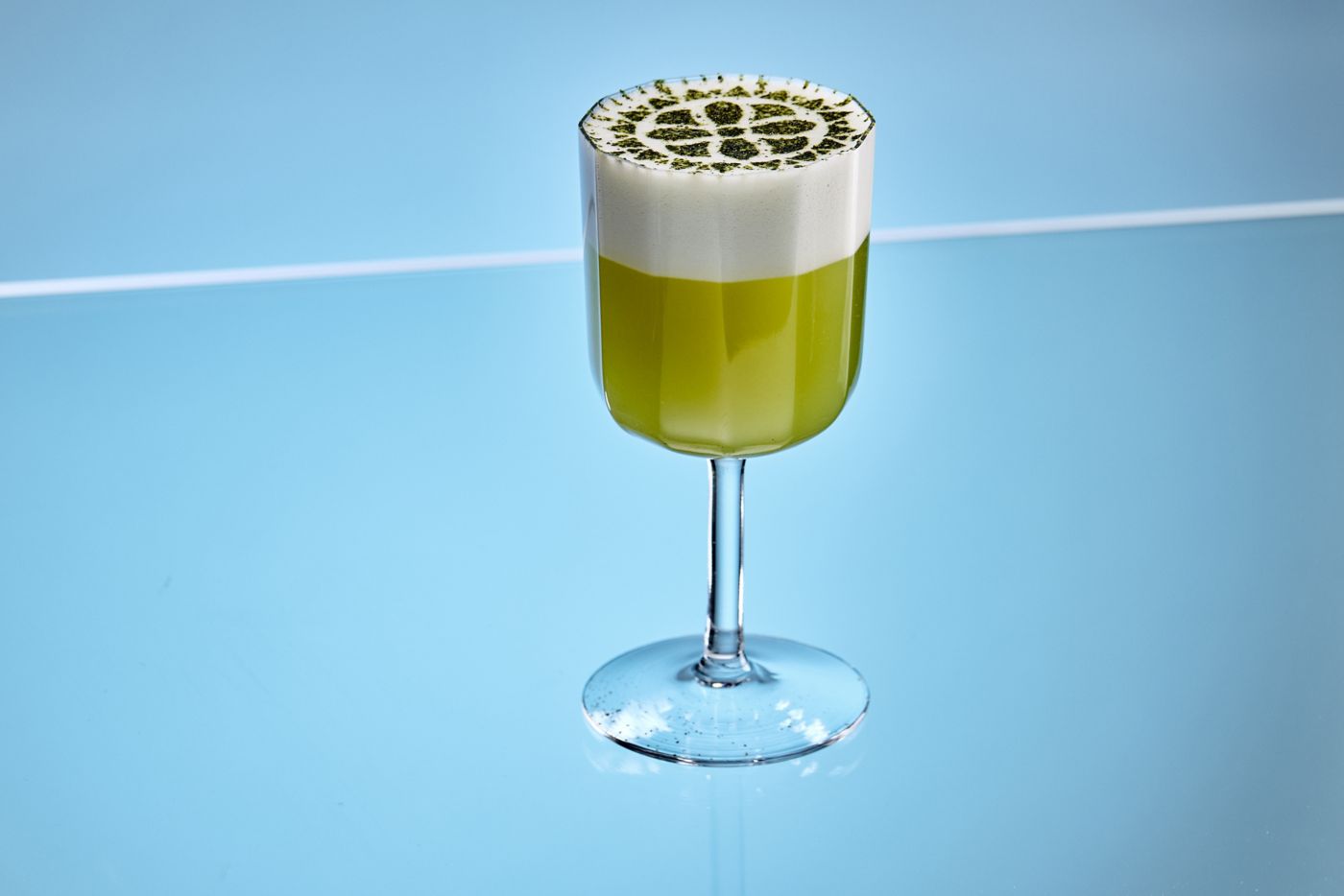 The Matcha Fizz cocktail against a blue background