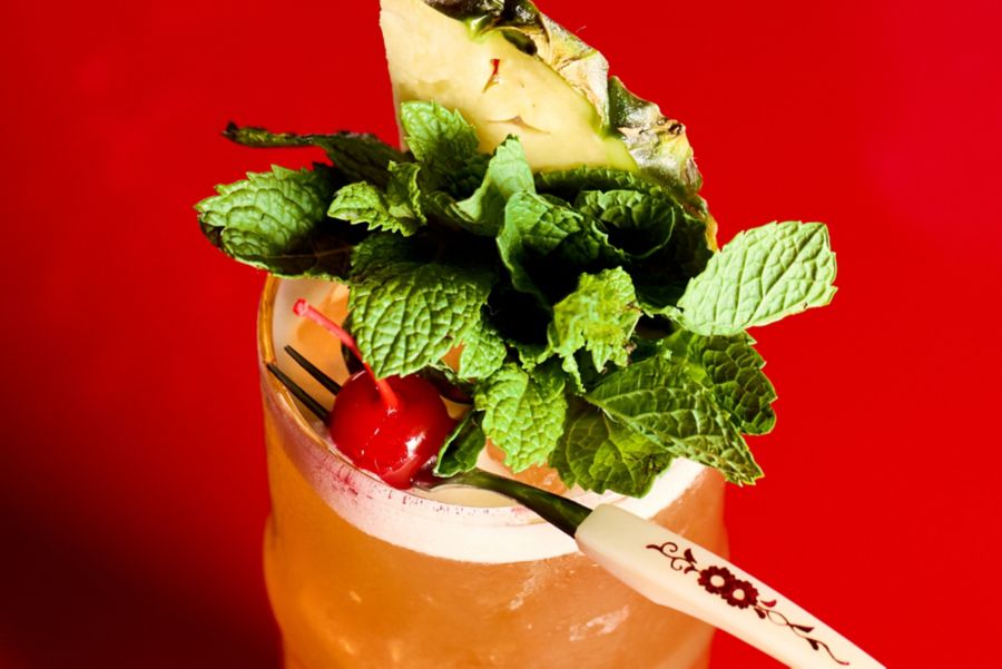 Mint, pineapple and a cherry garnish the Bahama Mama cocktail 