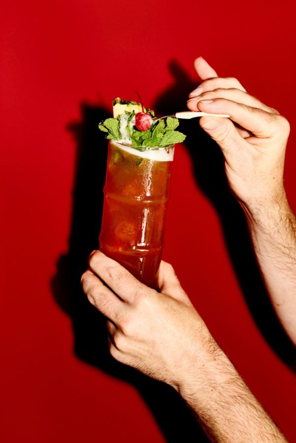 Holding a Bahama Mama cocktail