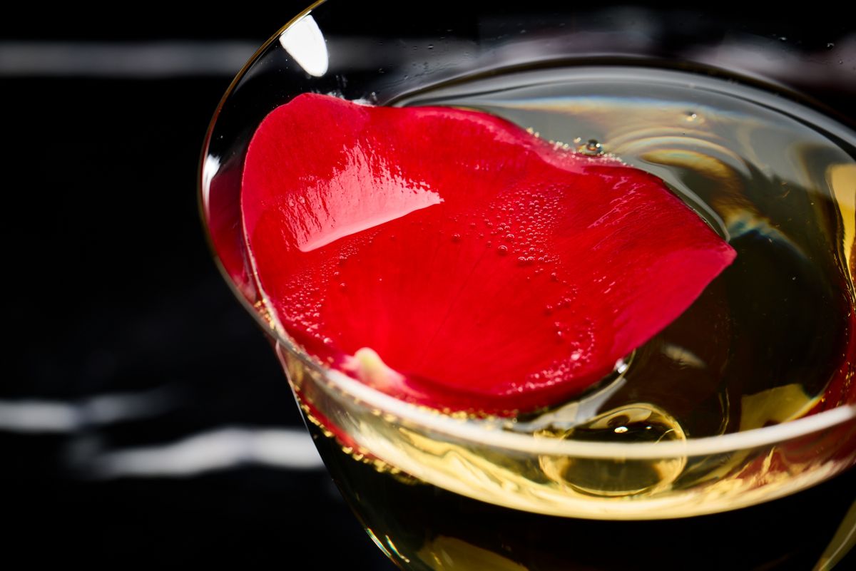 The rose petal garnish on top of the Death in the Afternoon cocktail