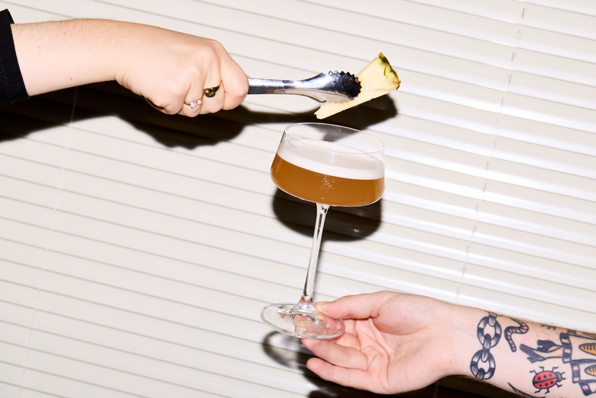 Finishing the Hotel Nacional cocktail with a wedge of pineapple