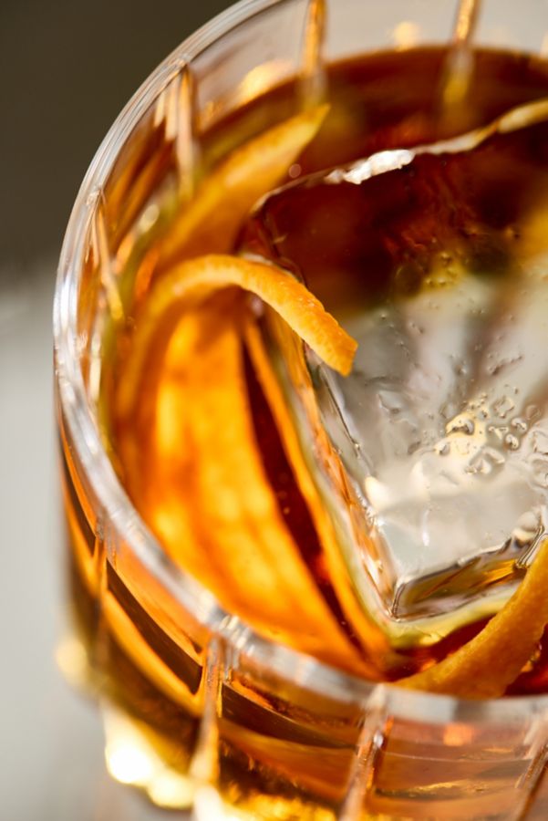 A close-up into the Remember The Alimony cocktail with an orange twist