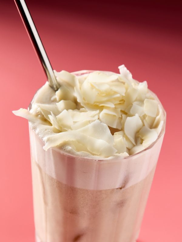 Up close at the Coconut Tamaretto Sour, garnished with coconut flakes