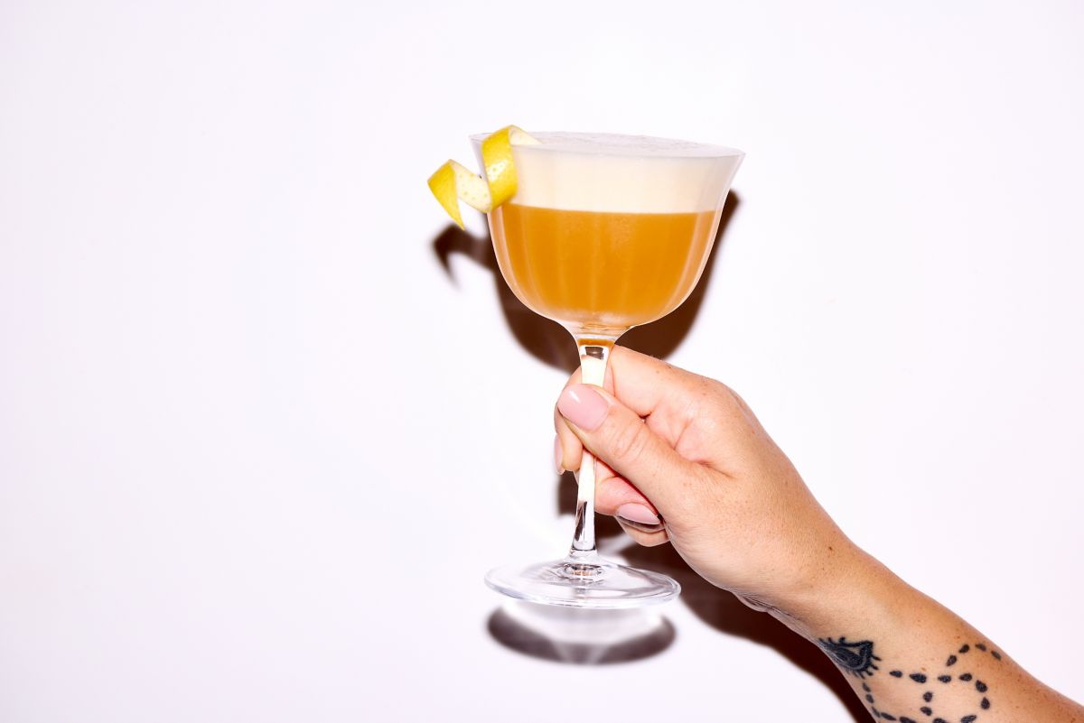 Holding a glass of Earl Grey MarTEAni