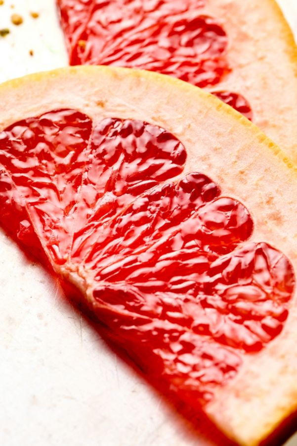 A close-up of pink grapefruit slices, used to garnish the Tokyo Sour 
