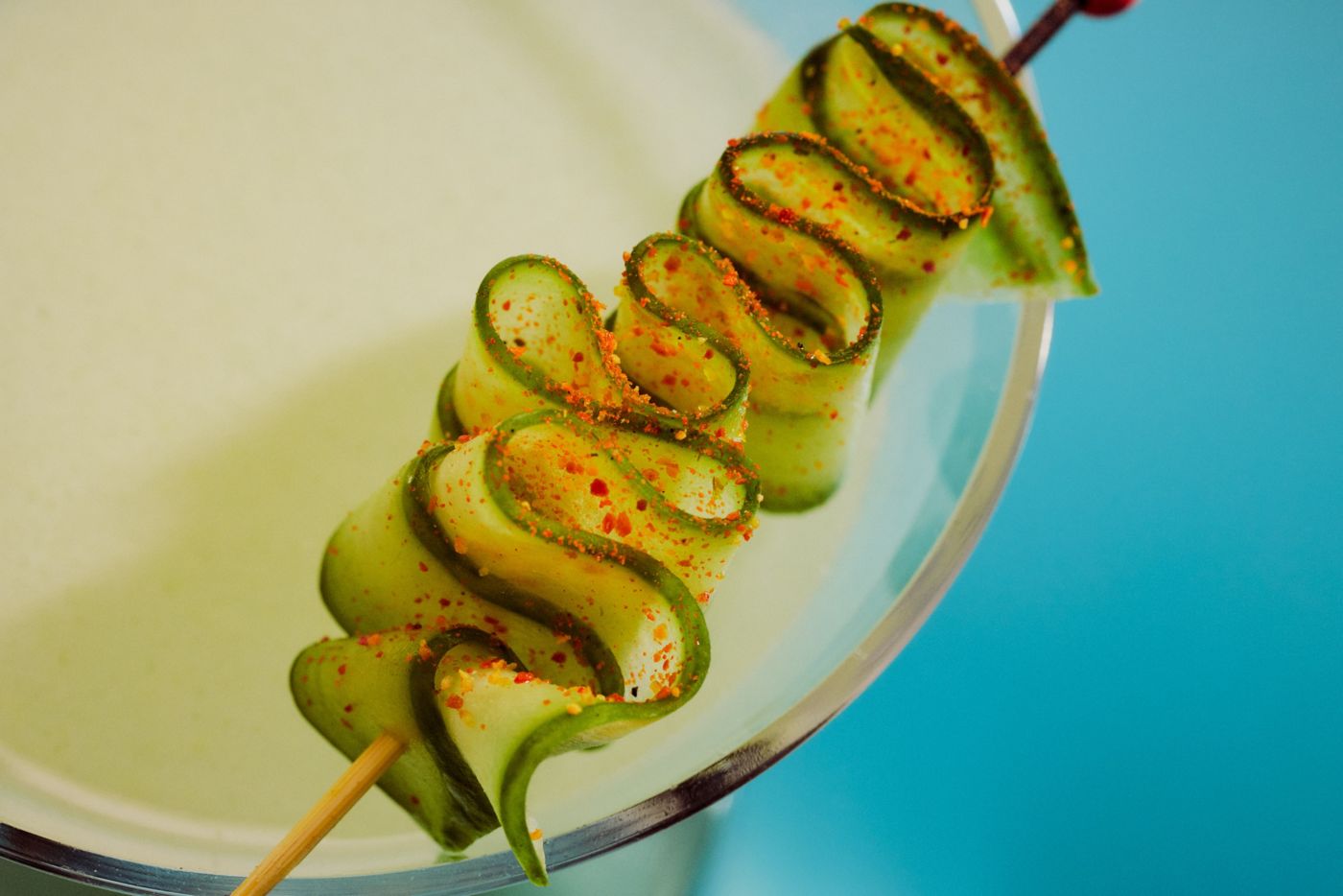 A skewered spiced cucumber garnish on top of the So Miso cocktail 