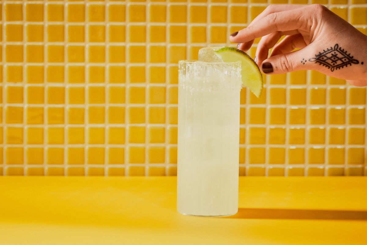 Reaching for the lime garnish on the Margarita Soda cocktail