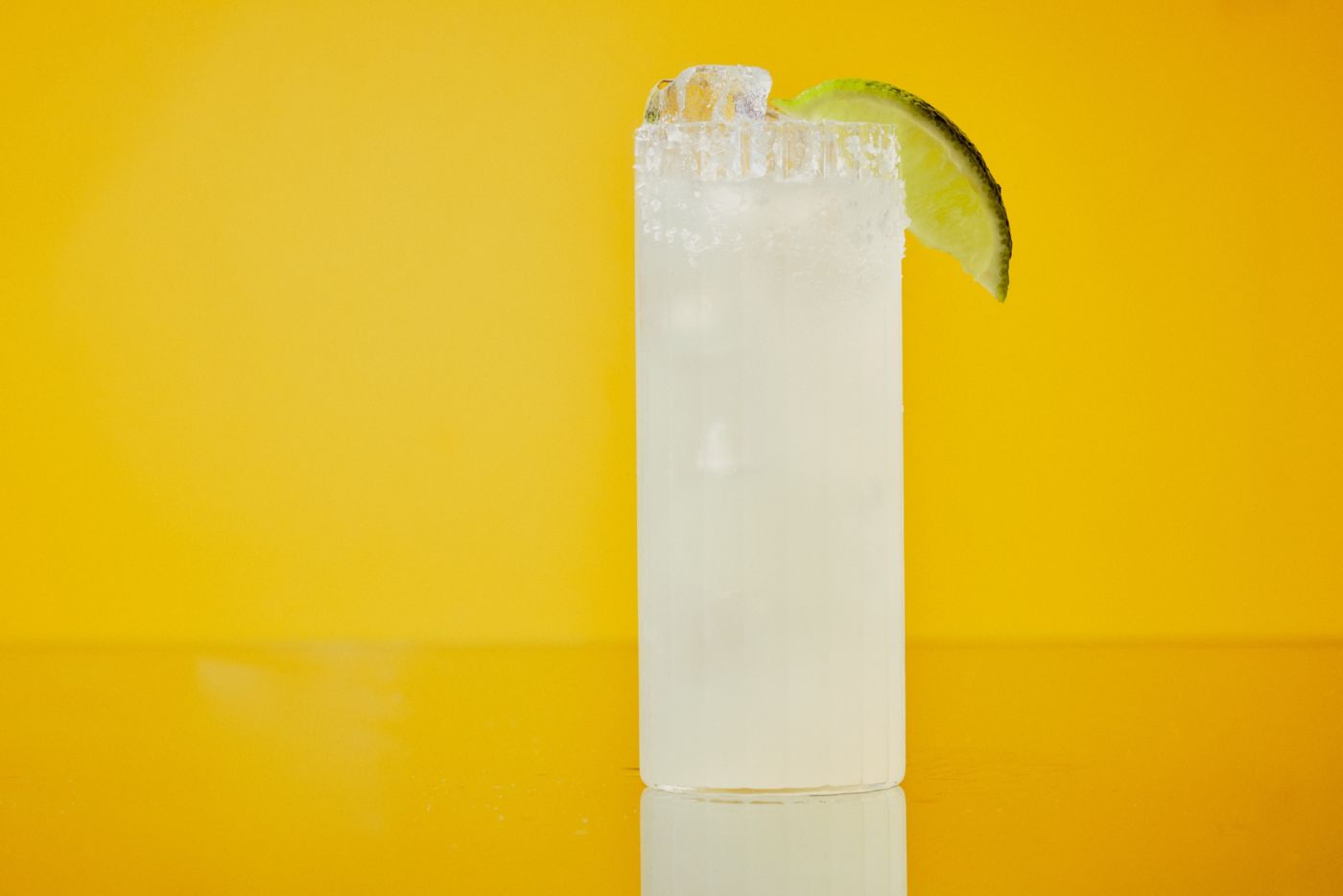 A Margarita Soda cocktail garnished with a lime wedge
