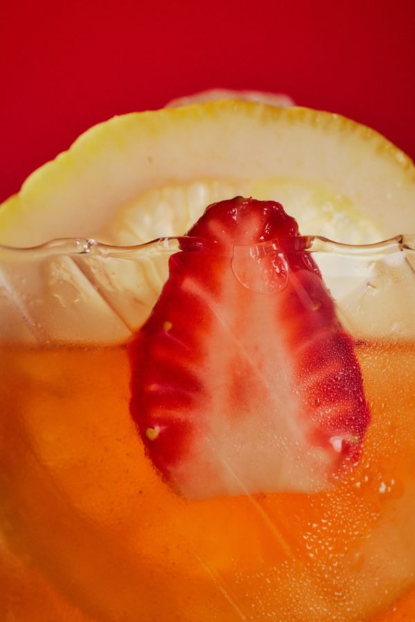 Holding the bitter-sweet rum cocktail, the Darryl Strawberry 